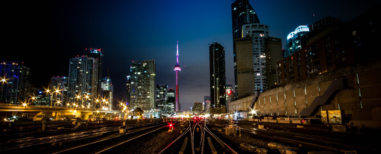 An image of Toronto and the CN Tower at night from the tracks