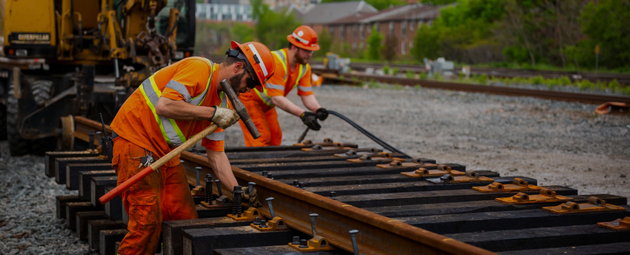 Two TTR workers working on train tracks