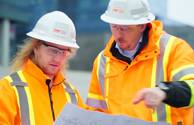 An image of two TTR employees reviewing something