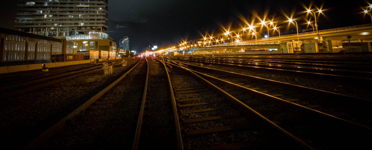 An image of a train station in Toronto viewed from the tracks at night