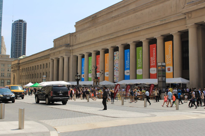 Image of the front of Union Station from the street with colourful banners hanging up