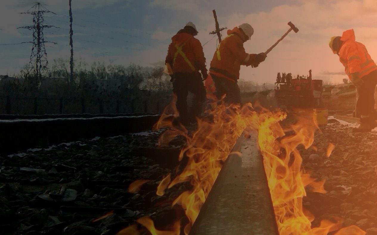 Image of TTR railway track workers working on a track that is in flames