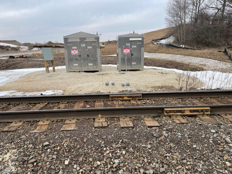 Signal and communication boxes beside train tracks