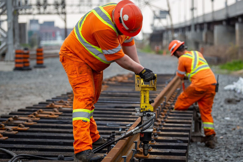 Two TTR Workers working on the track with large tools