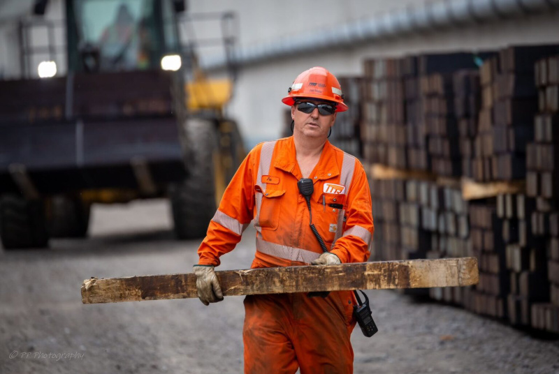 One TTR worker carrying an item walking towards the camera