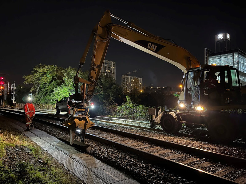 TTR workers working late at night on the tracks with large equipment