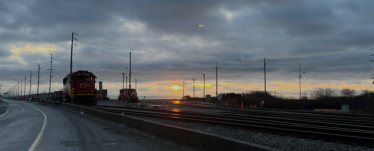 Image of CN train on railway tracks either at sunrise or sunset in Deltaport BC