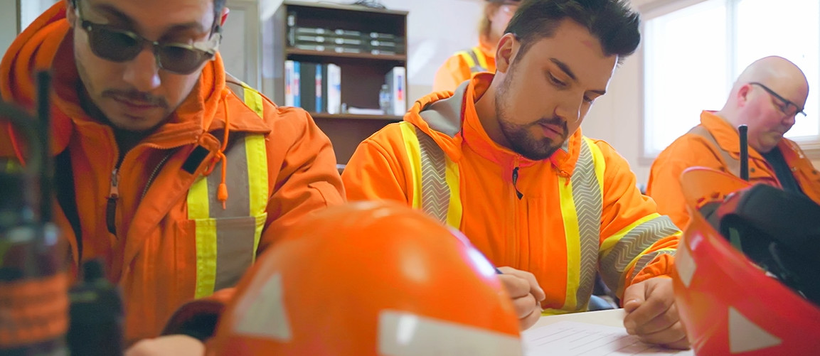 An image of TTR employees filling out paperwork